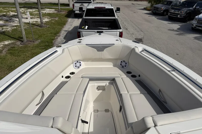 Slide: The Image of 2026 Sailfish 276 DC boat interior with cushioned seating and cup holders. - 11