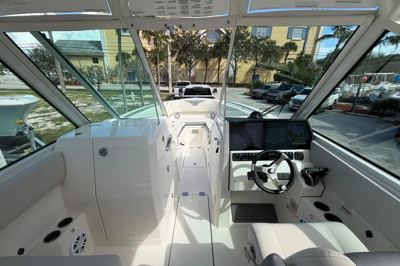 Slide: The Image of 2026 Sailfish 276 DC boat interior with modern dashboard and steering wheel. - 14