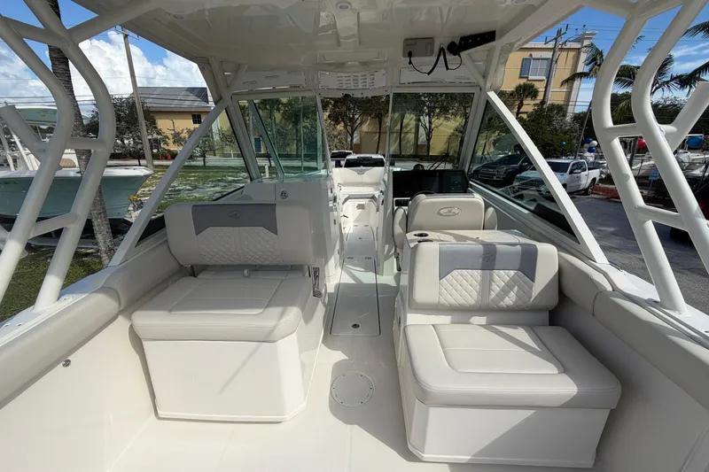 Slide: The Image of 2026 Sailfish 276 DC boat interior with cushioned seating and modern design. - 15