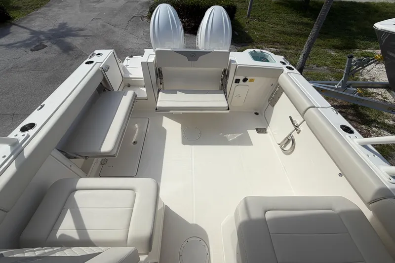 Slide: The Image of 2026 Sailfish 276 DC boat interior with cushioned seating and storage compartments. - 17