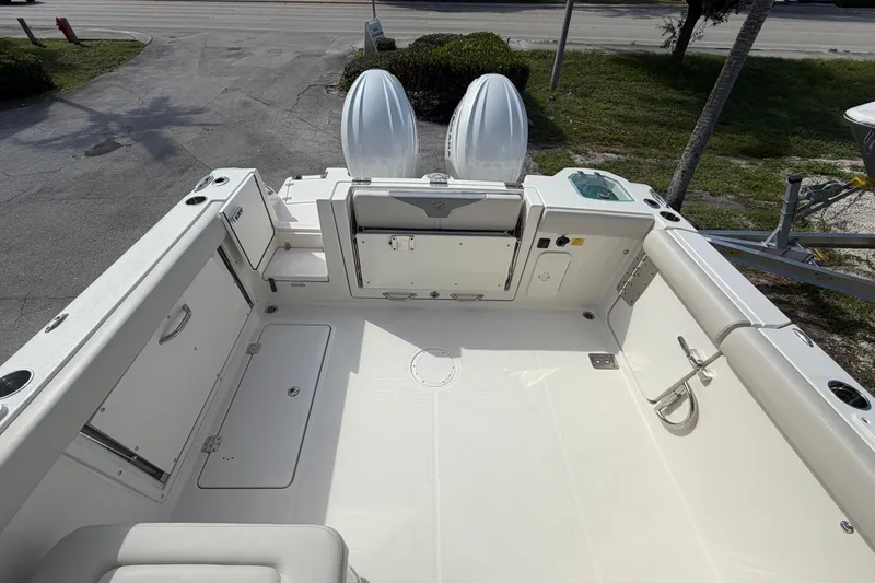 Slide: The Image of 2026 Sailfish 276 DC boat deck with dual engines, spacious layout, and storage compartments. - 18