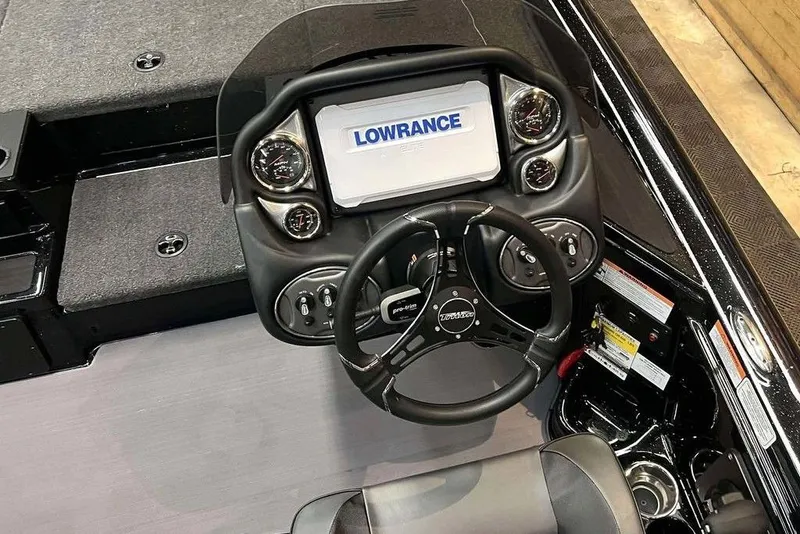 Slide: The Image of 2025 Triton 18 TrX boat dashboard with Lowrance display and steering wheel. - 7
