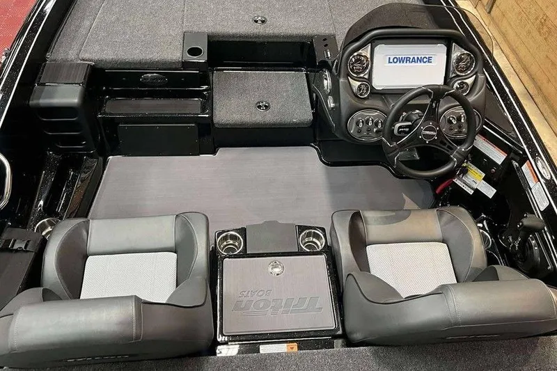 Slide: The Image of 2025 Triton 18 TrX boat interior with dual seats and Lowrance navigation system. - 8