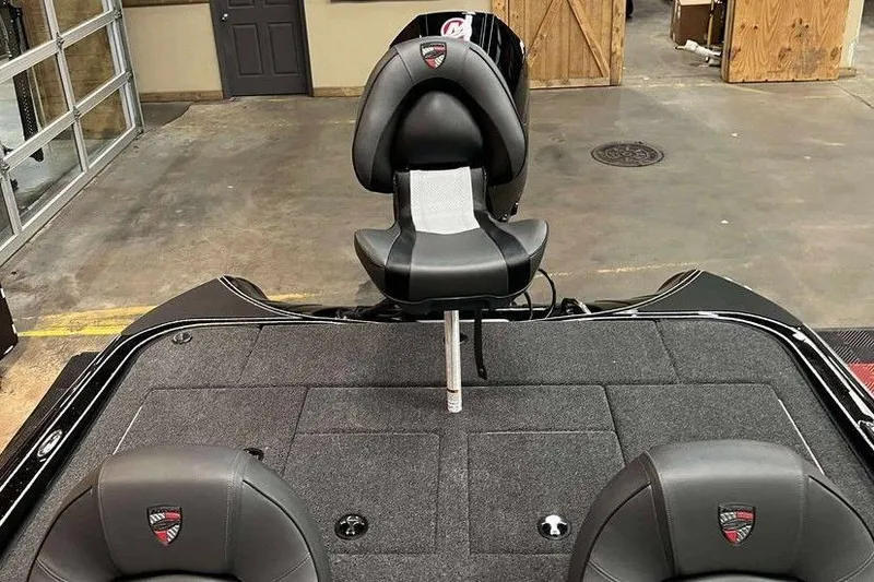 Slide: The Image of 2025 Triton 18 TrX boat interior with sleek seating and carpeted deck. - 9