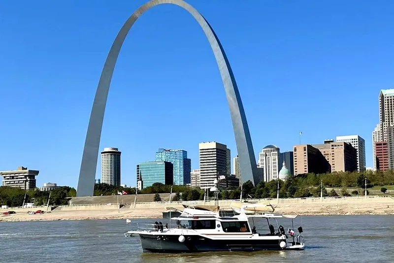 The Image of 2022 Ranger Tugs 43-CB boat on river with city skyline and arch. - 0