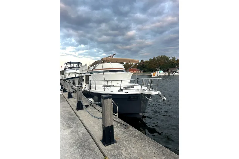 Slide: The Image of 2022 Ranger Tugs 43-CB yacht docked at marina under cloudy sky. - 13