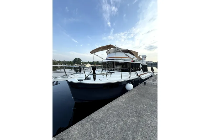 Slide: The Image of 2022 Ranger Tugs 43-CB yacht docked at marina under blue sky. - 14