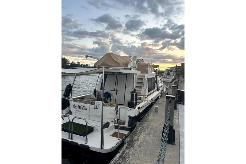 Slide: The Image of 2022 Ranger Tugs 43-CB docked at sunset, showcasing elegant design and spacious deck. - 15