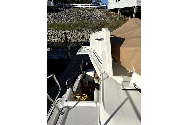 Slide: The Image of 2022 Ranger Tugs 43-CB boat with open hatch and covered seating area. - 16