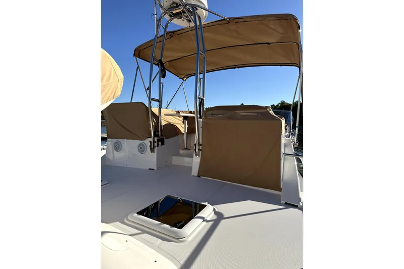 Slide: The Image of 2022 Ranger Tugs 43-CB boat deck with tan canopy and seating. - 17