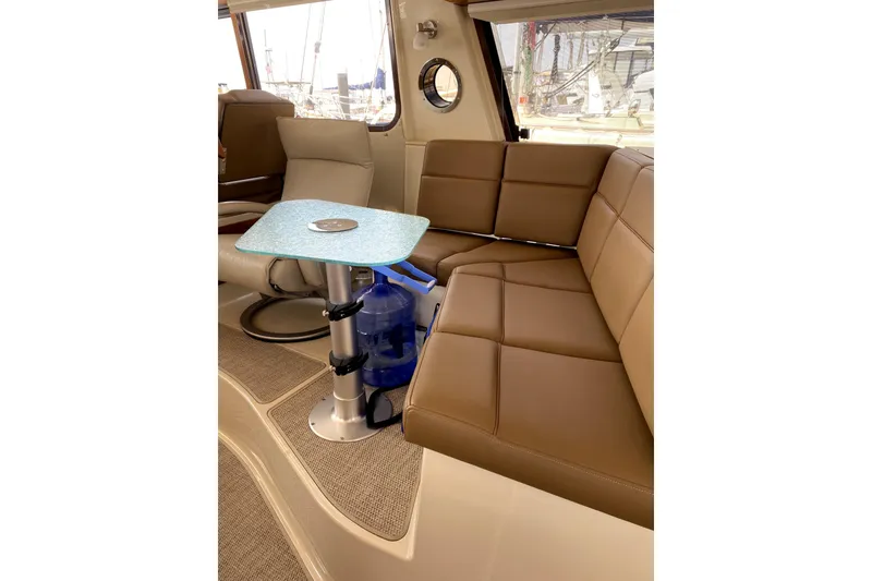 Slide: The Image of Interior of 2022 Ranger Tugs 43-CB with brown seating and modern table. - 27