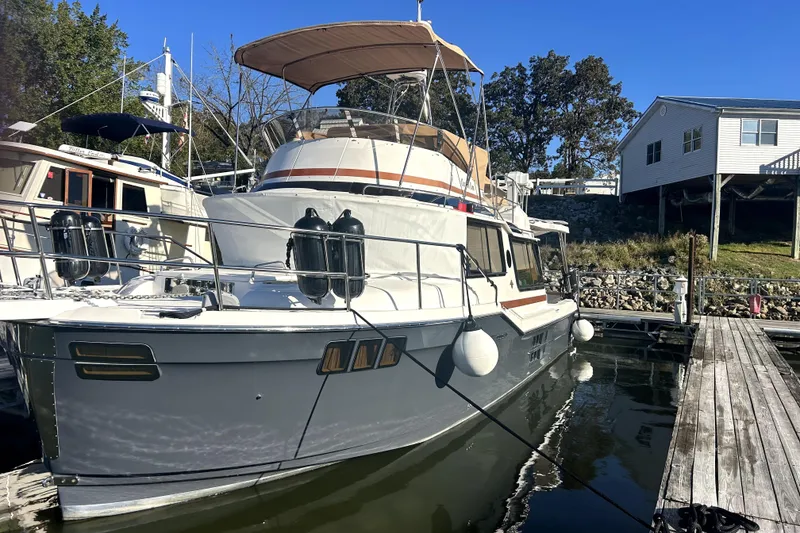 Slide: The Image of 2022 Ranger Tugs 43-CB boat docked at marina under clear blue sky. - 3