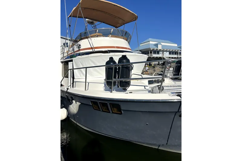 Slide: The Image of 2022 Ranger Tugs 43-CB boat docked with canopy and railings. - 4