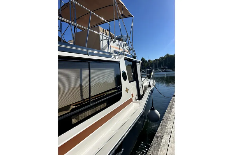 Slide: The Image of 2022 Ranger Tugs 43-CB docked, featuring sleek design and spacious upper deck. - 10