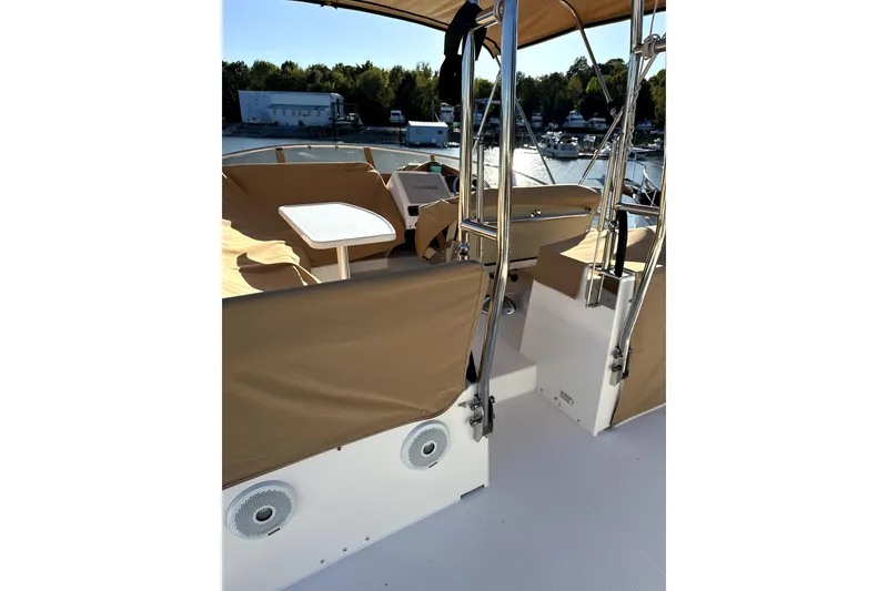 Slide: The Image of 2022 Ranger Tugs R-43 CB boat docked, featuring shaded deck and seating area. - 18