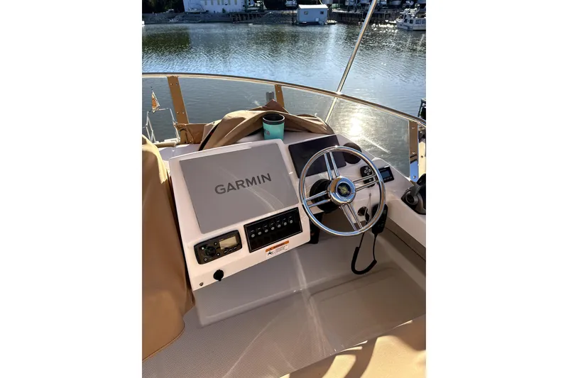 Slide: The Image of 2022 Ranger Tugs 43-CB boat with open hatch and covered seating area. - 19