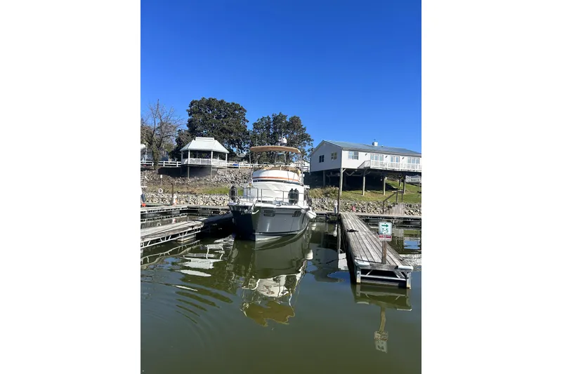Slide: The Image of 2022 Ranger Tugs 43-CB docked at a marina under a clear blue sky. - 2