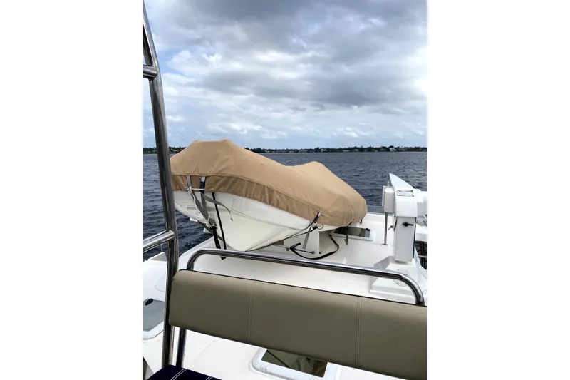 Slide: The Image of 2022 Ranger Tugs 43-CB boat deck with tan canopy and seating. - 20