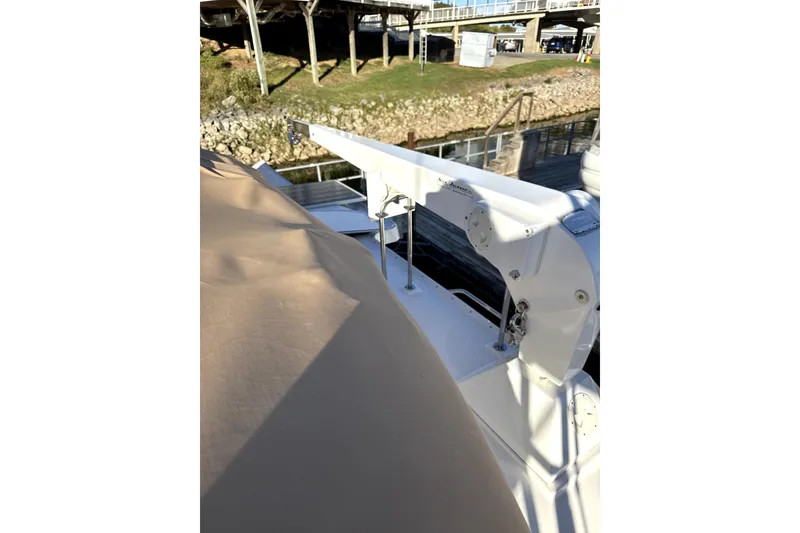 Slide: The Image of 2022 Ranger Tugs 43-CB helm with Garmin navigation, overlooking serene waterfront. - 22