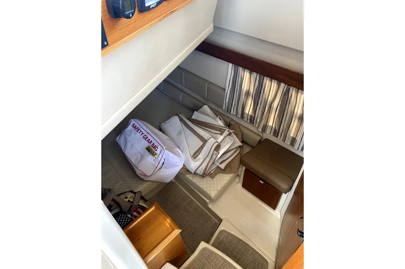 Slide: The Image of 2022 Ranger Tugs R-43 CB boat deck with tan covers and white table. - 29