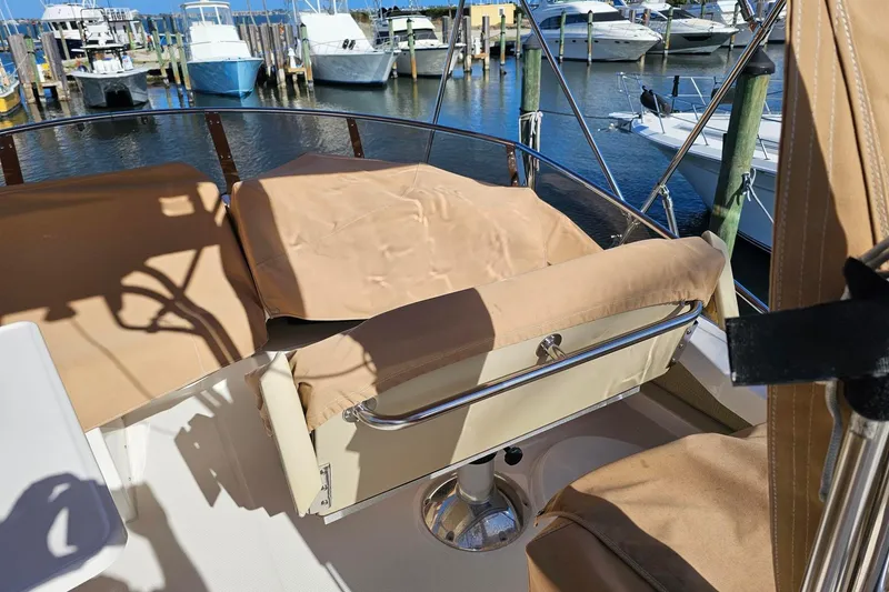 Slide: The Image of 2022 Ranger Tugs R-43 CB boat interior with covered seating at marina. - 30