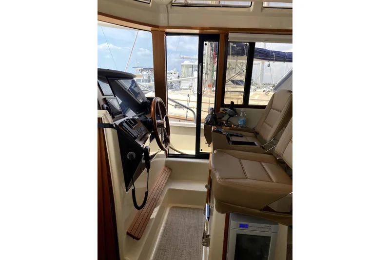 Slide: The Image of Interior of 2022 Ranger Tugs 43-CB boat with helm and seating area. - 33