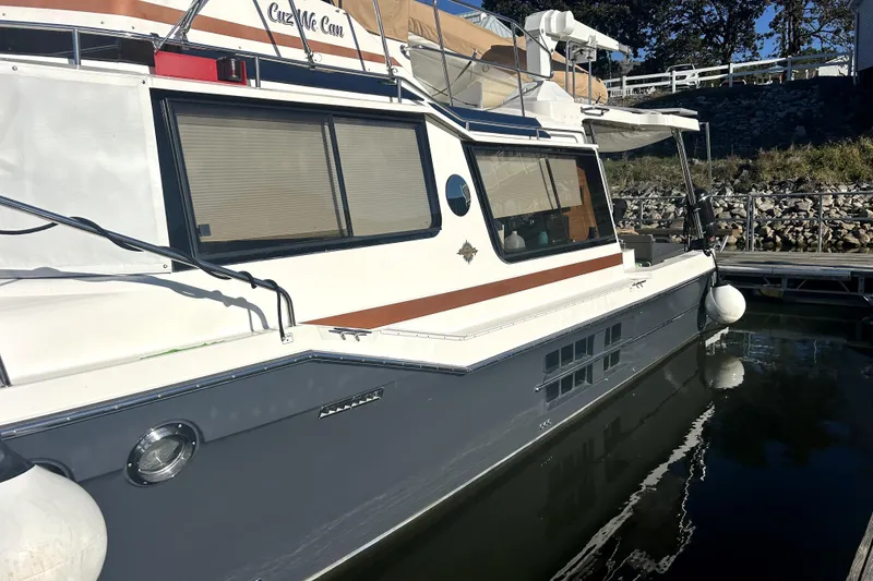 Slide: The Image of 2022 Ranger Tugs 43-CB boat docked, featuring sleek design and modern amenities. - 5