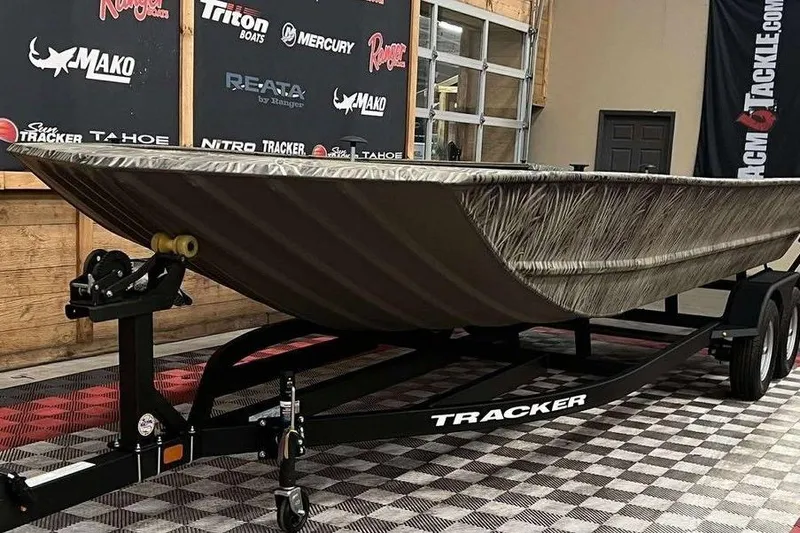 Slide: The Image of 2026 Tracker Grizzly 1860 Utility boat on trailer in showroom. - 5