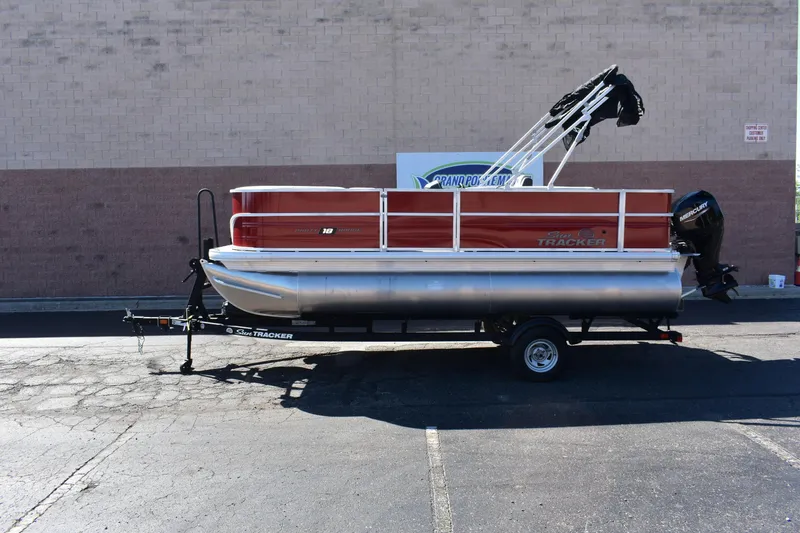 The Image of 2026 Sun Tracker Party Barge 18 DLX pontoon boat on trailer, parked outdoors. - 0