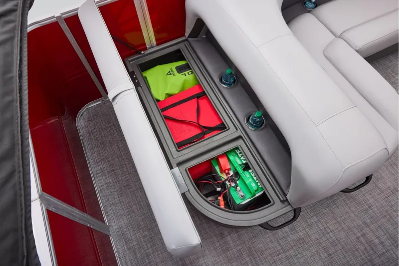 Slide: The Image of Manufacturer Provided Image: 2026 Sun Tracker Party Barge 18 DLX storage compartment with safety gear and battery. - 56