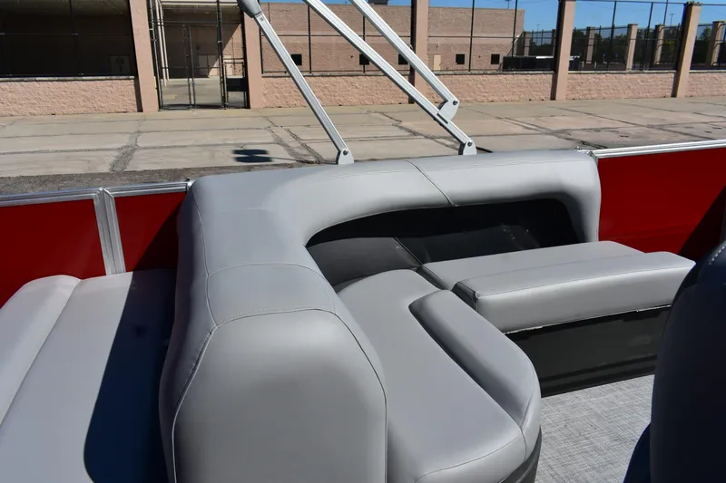 Slide: The Image of 2026 Sun Tracker Party Barge 18 DLX with gray seating and red accents. - 6