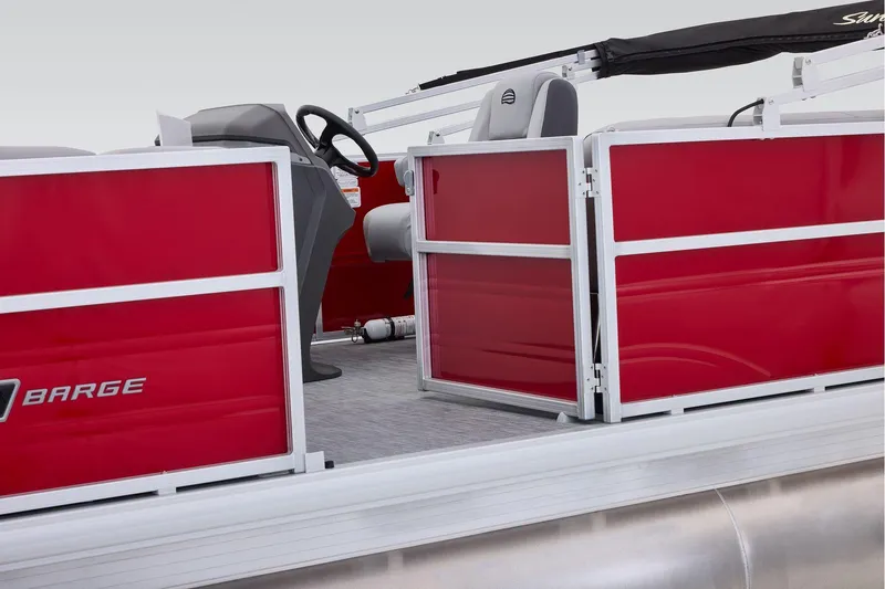 Slide: The Image of Manufacturer Provided Image: 2026 Sun Tracker Party Barge 18 DLX pontoon boat with red paneling and steering console. - 64