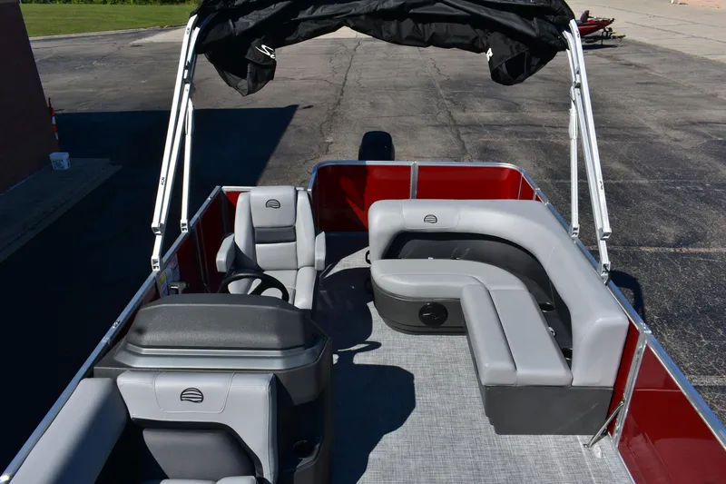 Slide: The Image of 2026 Sun Tracker Party Barge 18 DLX with gray seating and canopy, docked on pavement. - 68