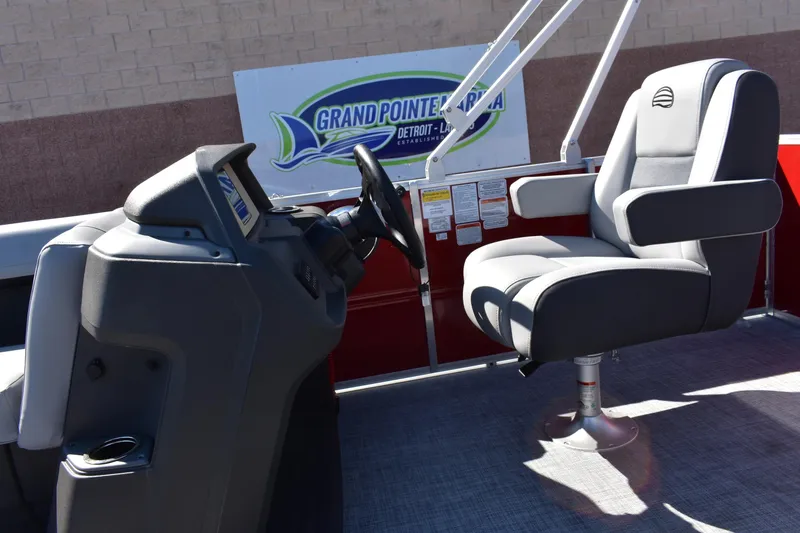 Slide: The Image of 2026 Sun Tracker Party Barge 18 DLX interior with steering console and captain's chair. - 70