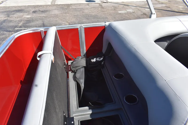 Slide: The Image of 2026 Sun Tracker Party Barge 18 DLX interior with red accents and seating storage. - 72