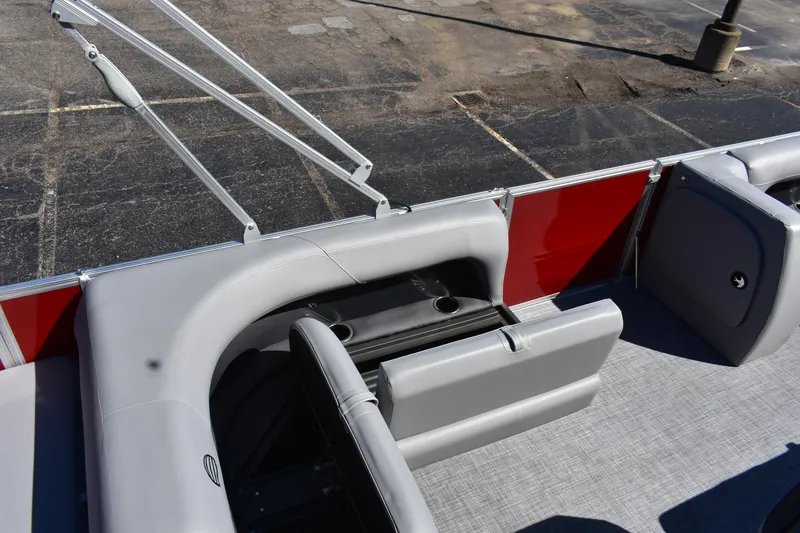Slide: The Image of 2026 Sun Tracker Party Barge 18 DLX interior with gray seating and red paneling. - 73