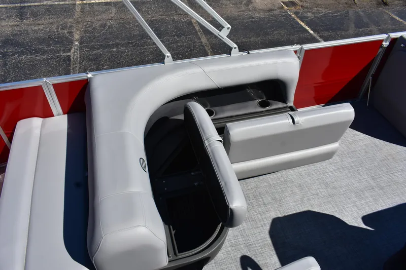 Slide: The Image of 2026 Sun Tracker Party Barge 18 DLX interior with gray seating and cup holders. - 74