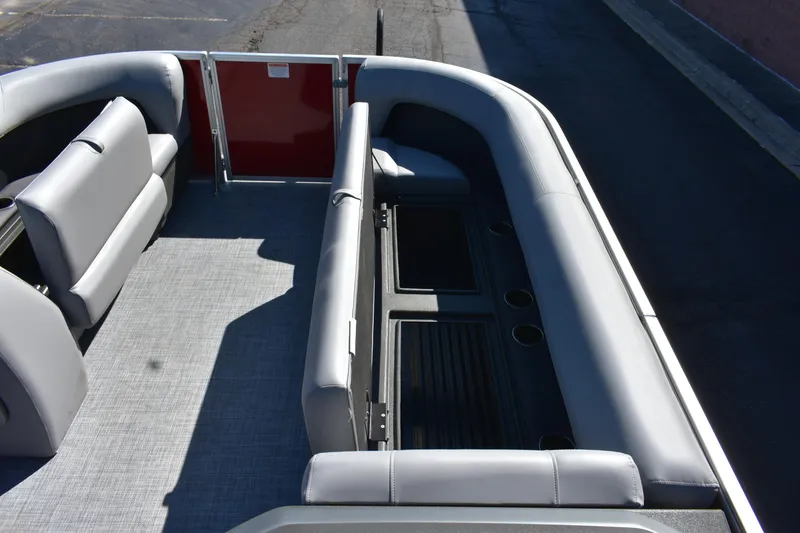 Slide: The Image of 2026 Sun Tracker Party Barge 18 DLX interior with gray seating and cup holders. - 76