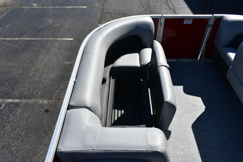 Slide: The Image of 2026 Sun Tracker Party Barge 18 DLX interior with gray seating and storage. - 77