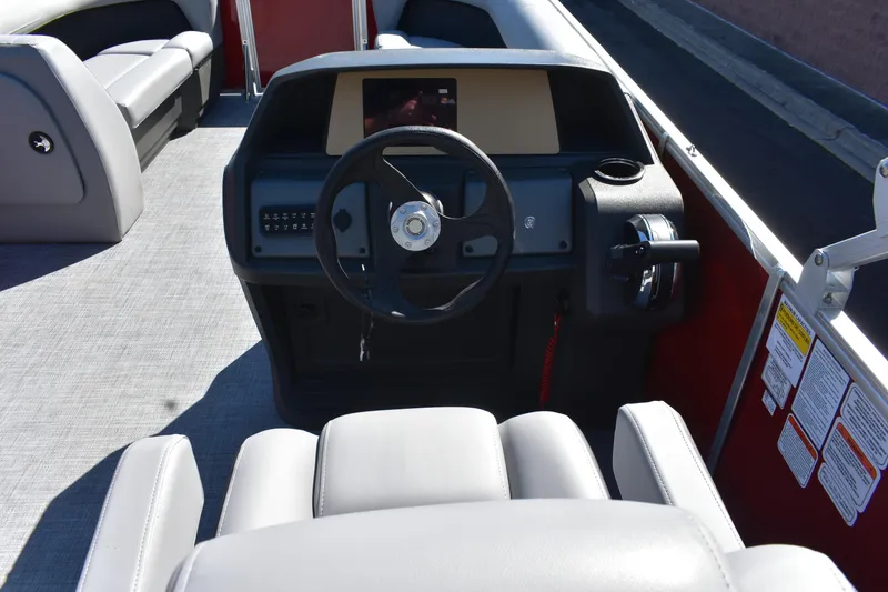 Slide: The Image of 2026 Sun Tracker Party Barge 18 DLX interior with steering wheel and seating. - 79
