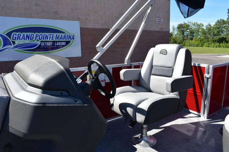 Slide: The Image of 2026 Sun Tracker Party Barge 18 DLX interior with steering wheel and captain's chair. - 8