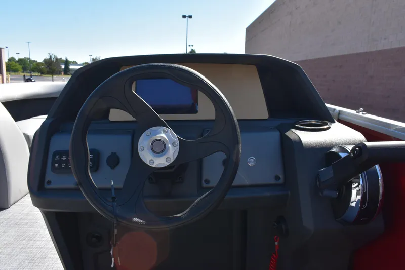 Slide: The Image of 2026 Sun Tracker Party Barge 18 DLX steering console with modern controls and display. - 81