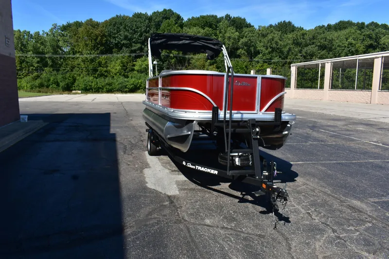 Slide: The Image of 2026 Sun Tracker Party Barge 18 DLX pontoon boat on trailer, parked outdoors. - 83