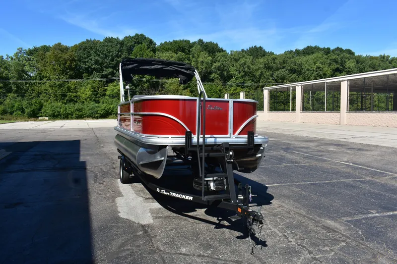 Slide: The Image of 2026 Sun Tracker Party Barge 18 DLX pontoon boat on trailer, parked outdoors. - 84