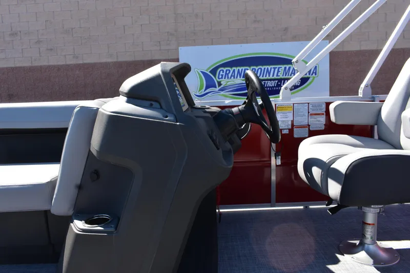 Slide: The Image of 2026 Sun Tracker Party Barge 18 DLX interior with steering console and seating. - 9