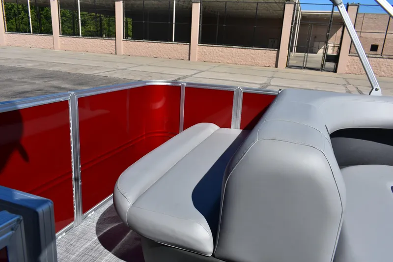 Slide: The Image of 2026 Sun Tracker Party Barge 18 DLX with red paneling and gray seating. - 90