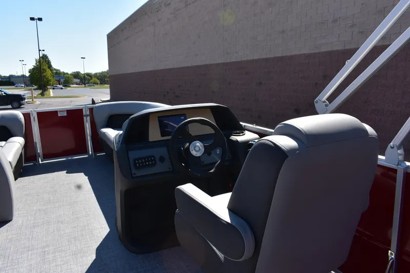 Slide: The Image of 2026 Sun Tracker Party Barge 18 DLX interior with steering console and seating. - 91