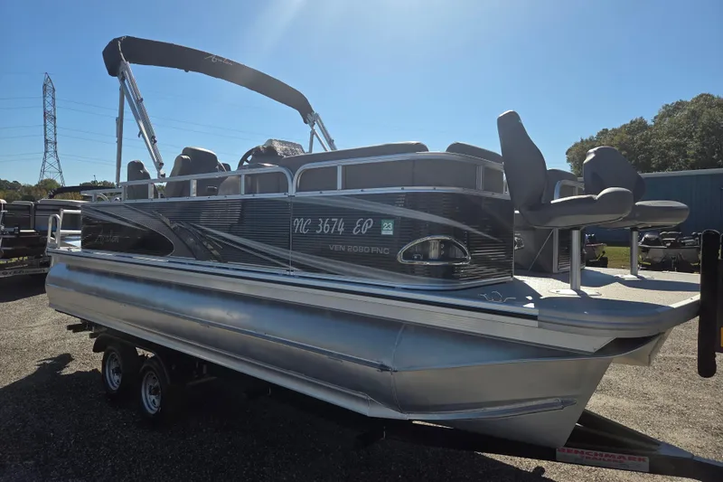 Slide: The Image of 2020 Avalon Venture Fish N Cruise 20' pontoon boat on trailer, sunny day. - 3
