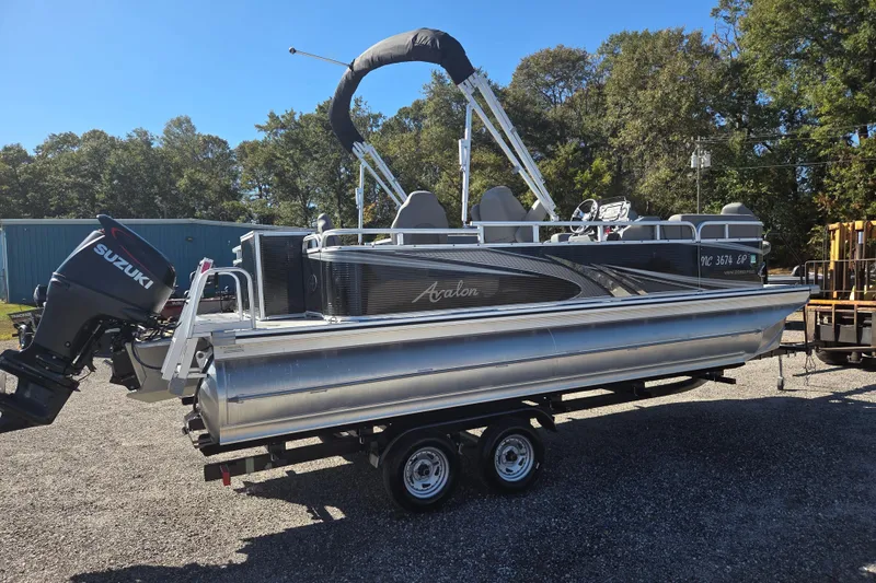 Slide: The Image of 2020 Avalon Venture Fish N Cruise 20' pontoon boat with Suzuki outboard motor on trailer. - 4