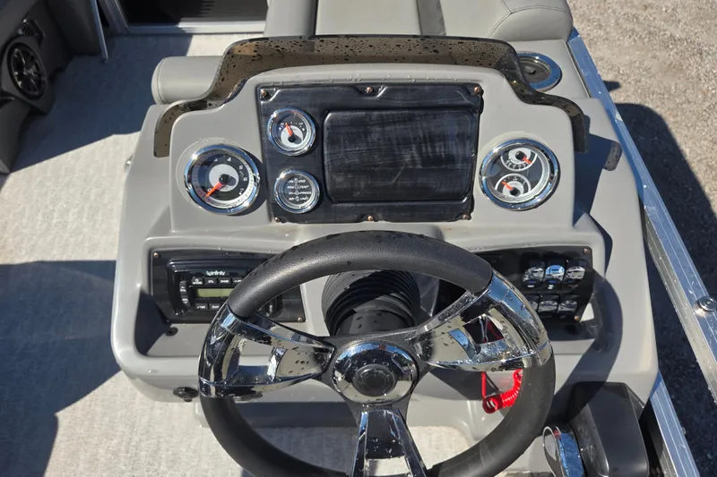 Slide: The Image of 2020 Avalon Venture Fish N Cruise boat dashboard with steering wheel and gauges. - 8